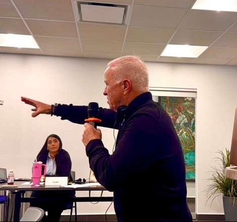 George Dans speaking with microphone